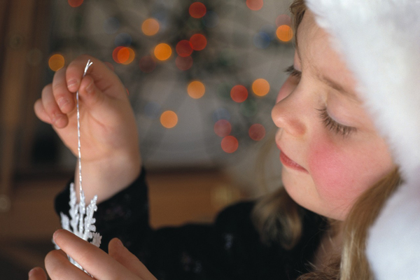 Young Girl Playing with Ornament Young Girl Playing with Ornament
